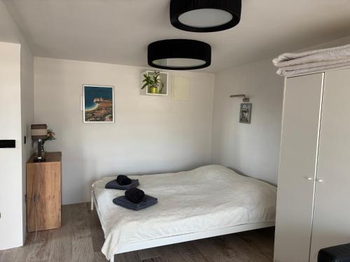 a bedroom with a bed with two hats on it at Trinity in Balatonalmádi