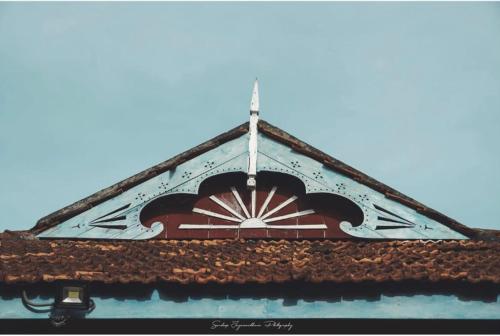 a clock tower with a cross on top of it at Catumaran Jaffna in Jaffna