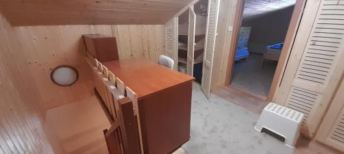 a room with a wooden desk in a house at Ubytovanie Clematis in Martinske Hole