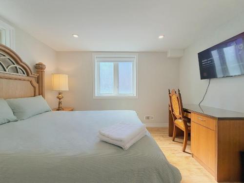 a bedroom with a bed and a flat screen tv at Cozy Rooms in Bright Walkout Suite - Newly Renovated in 2026 in Richmond Hill