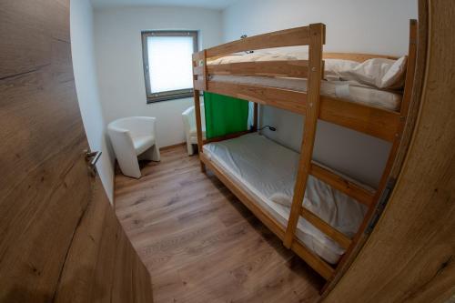 a room with two bunk beds and a door at Ferienwohnung an der Zwota in Klingenthal