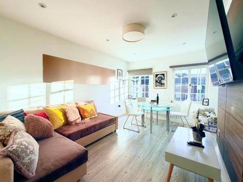 a living room with a couch and a table at Hampstead 4-bedrooms condo apartment in London