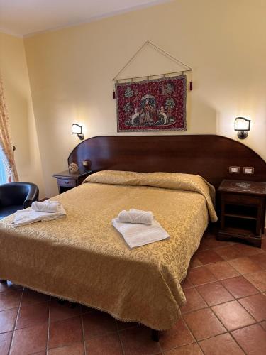 a bedroom with a bed with two towels on it at Palazzo Mascambruno in Cariati