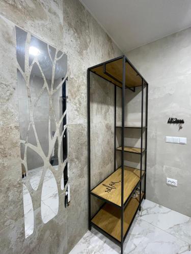 a glass shelf in a room with a wall at AmurRelaxCreative in Khmelnytskyi