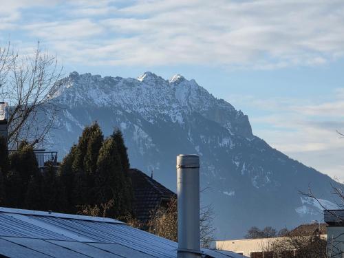 a snow covered mountain in front of a house at Coraline -Koblach, 6-10 P, 3 Schlafzimmer, Küche, riesige Terrasse, Parkplatz, WiFi, Stellplatz Ski in Koblach