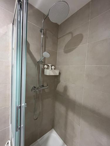 a shower with a glass door in a bathroom at Léopard vert - Clim - Tout inclus in Aubagne