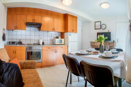 a kitchen with a table with chairs and a dining room at Hiška 231, 2 karti za Terme 3000, Moravske Toplice in Moravske-Toplice