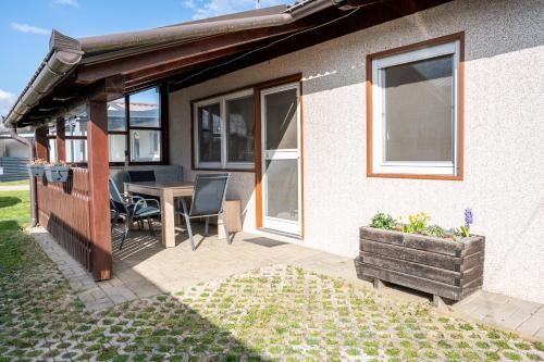 a patio of a house with a table and chairs at Hiška 231, 2 karti za Terme 3000, Moravske Toplice in Moravske-Toplice