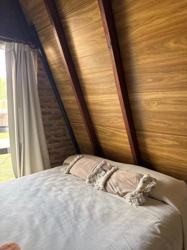 a stuffed animal laying on top of a bed at Casa Alpina in Navarro
