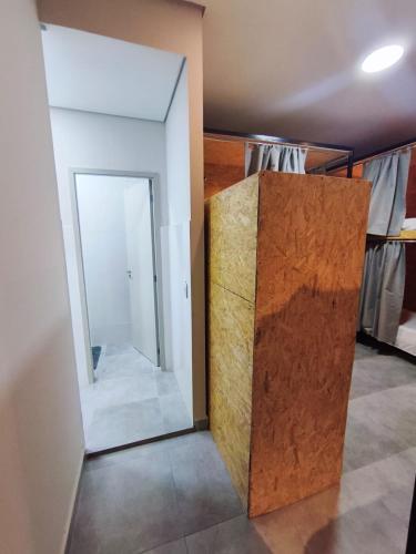 a room with a mirror and a door in it at Hostel Vila Universitária in Bauru