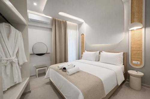 a bedroom with a bed with a towel on it at NOÈA Luxury Suites in Kavála
