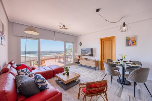 a living room with a red couch and a table at Mediterranean & golf dreams in Alicante