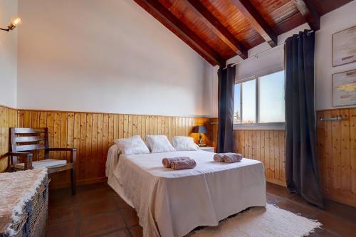 a bedroom with a large bed and a window at Authentic apartment with pool and sea view in Estepona