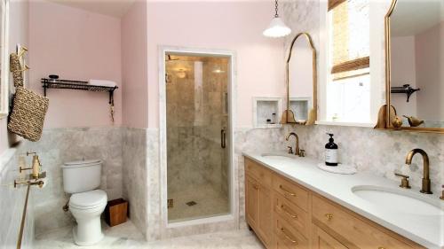 a bathroom with a shower and a toilet and a sink at 12 Pearls in Cape May Point