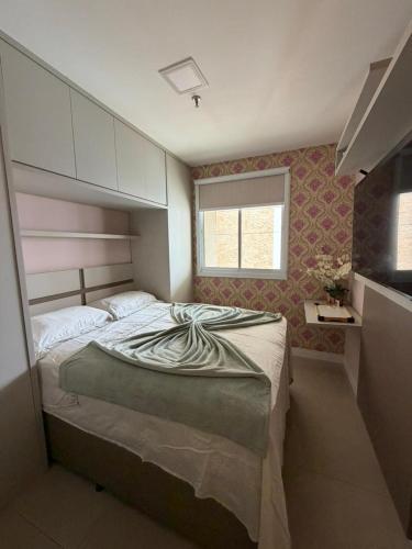 a bedroom with a large bed in a room at JUPET Studio in Brasília