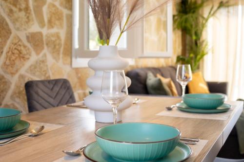 a dining room table with bowls and a vase at Villa Renata in Kontokali