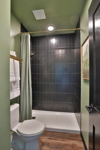a bathroom with a tub and a toilet and a shower at Urban Collective Boutique Hotel in Edwardsville