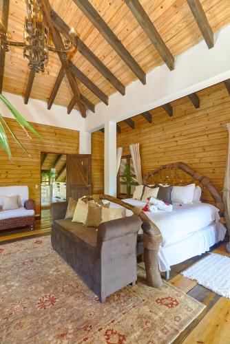 a bedroom with a large bed and a couch at Villa ines-4X4only-Jarabacoa-View-Jacuzzi-5BR in Jarabacoa