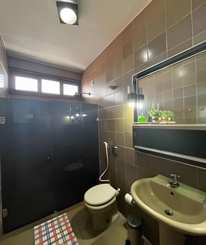 a bathroom with a toilet and a sink at Studio Caju in Mossoró