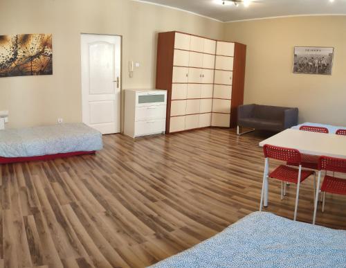 a room with a table and a bed and a desk at Noclegi Włocławek in Włocławek