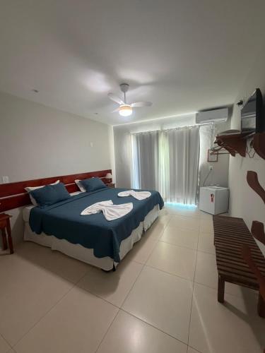 a bedroom with a bed and a television in it at Pousada No Alto da Serra Conservatória in Conservatória
