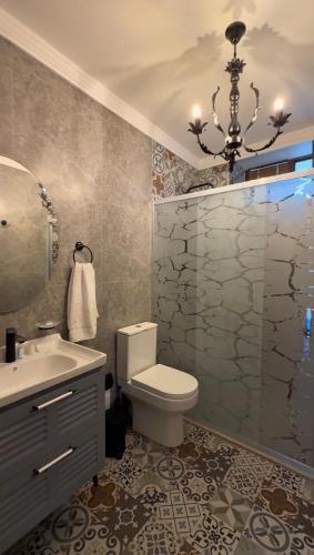 a bathroom with a toilet and a sink and a shower at Comfort Villa Sheki in Sheki