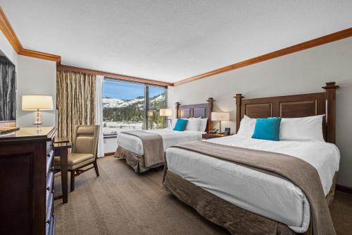 a hotel room with two beds and a window at Olympic Valley Summer Stay: Everline Resort & Spa! in Olympic Valley