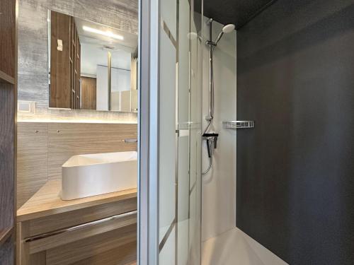 a bathroom with a shower and a sink at Feriendorf Seeblick - Tiny Chalet Nr 8 in Neunburg vorm Wald