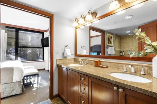 a bathroom with two sinks and a large mirror at Resort Perks! Everline Corner Retreat w/ 3 Units in Olympic Valley