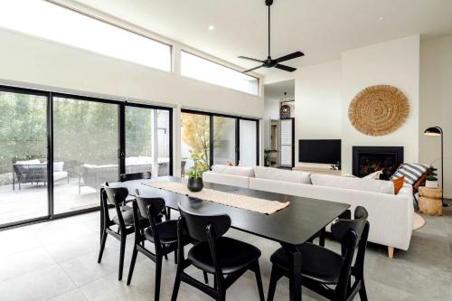 a living room with a table and a couch at Super-Styled Light-Filled Eco Home in Torquay