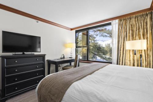 a bedroom with a large bed and a large window at Valley-View Unit in Everline Resort: Premier Perks in Olympic Valley