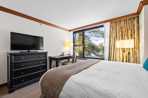 a bedroom with a large bed and a large window at High Sierra Summer Stay in Everline Resort & Spa! in Olympic Valley