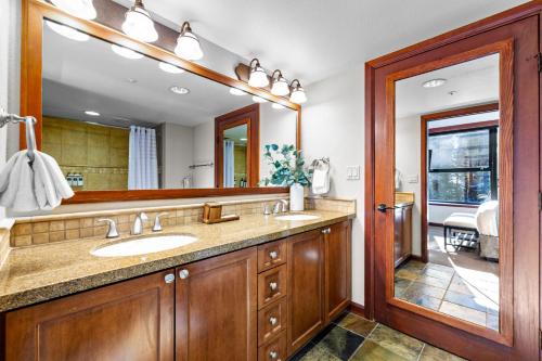 a bathroom with a sink and a mirror at High Sierra Summer Stay in Everline Resort & Spa! in Olympic Valley