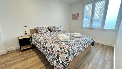 a bedroom with a bed with two pillows on it at Les Jonquilles in Vernon
