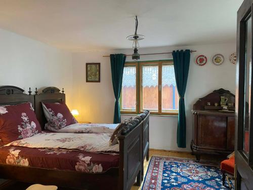 a bedroom with a bed and a window at Casa La Casiru 6 nature in Straja