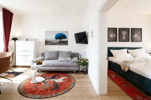 a living room with a bed and a couch at Altstadt Suites am Kamp, Parkhaus möglich in Paderborn
