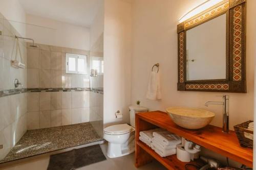 a bathroom with a sink and a toilet and a mirror at Baja Beach Pad at Cerritos in El Pescadero