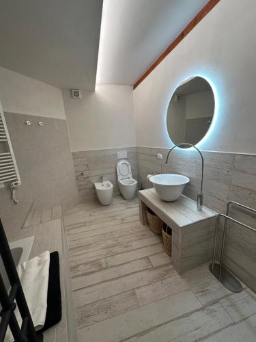 a bathroom with two toilets and a sink and a mirror at Le Cantine della Nelli in Genoa