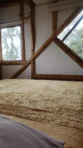 a room with a window and a bed in a room at Torre de Guadua in Medellín