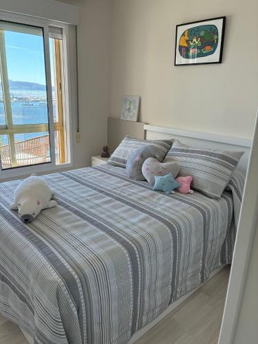 a bedroom with a bed with stuffed animals on it at Edificio el parque in Sanxenxo