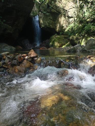 a waterfall in a river with rocks and water at Cabañas Las Yayas in San Pablo Número Dos