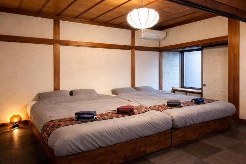 a bedroom with a large bed with pillows on it at 加美屋リゾート出雲大社神迎の道 杵と月 in Taisha