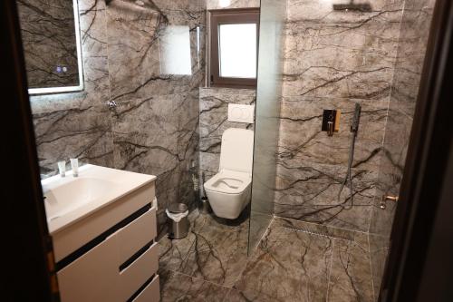 a bathroom with a toilet and a sink at Hotel Panorama in Berat