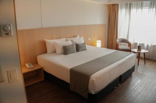a bedroom with a large bed in a hotel room at Dazzler by Wyndham Lima Miraflores in Lima