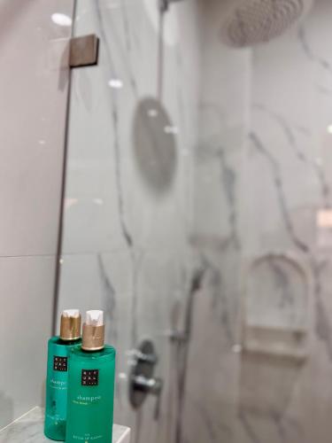 a bathroom with two green bottles on a sink at SOHO Rooftop 360 Sunset Edition in Essaouira