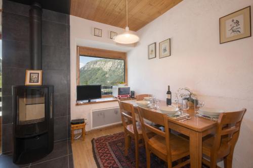 a dining room with a table and a fireplace at Résidence Igloo in Le Tour