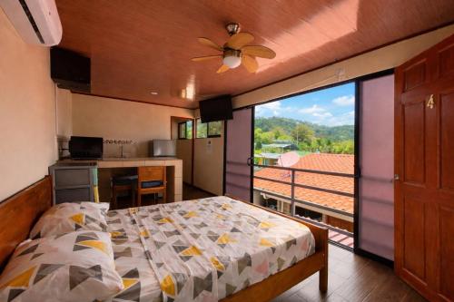 a bedroom with a bed and a balcony with a view at Good Vibes Apartments in Talamanca