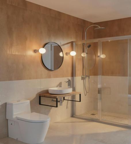 a bathroom with a toilet and a sink and a shower at Under The Palm Tree - Boutique Stay Experience in Áno Meriá