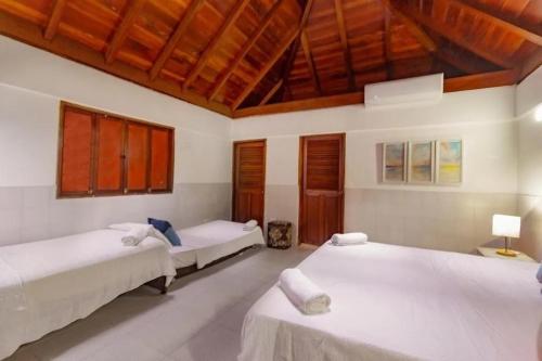 a bedroom with two beds and a wooden ceiling at Casa bela in Cartagena de Indias