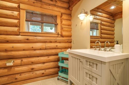a bathroom with a sink and wooden walls at Walk to Pine Mountain Lake: Spacious Family Cabin in Groveland